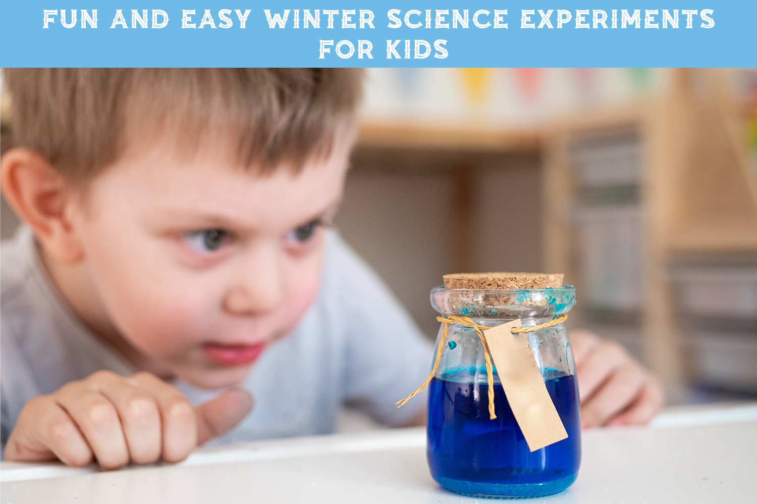 A kid looking at a glass jar filled with blue liquid - one of the fun science experiments for kids.