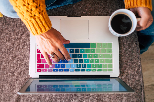 woman on laptop with rainbow keys